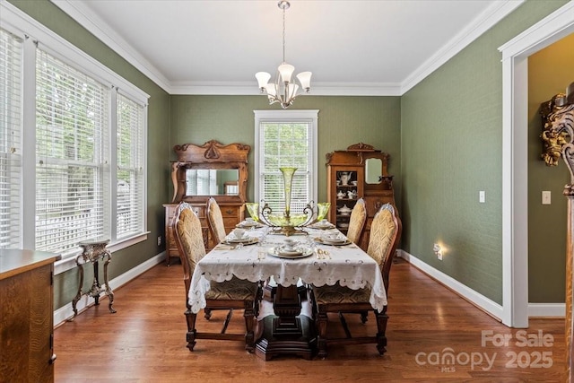 dining area featuring an inviting chandelier, wood finished floors, and baseboards