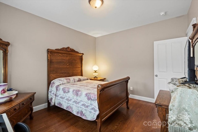 bedroom featuring wood finished floors and baseboards
