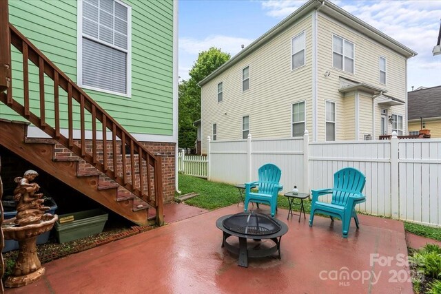 view of patio / terrace with a fire pit and fence