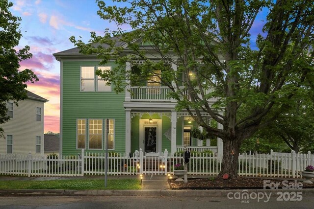 136 Water Oak Dr, Mooresville, NC 28117 - view of front facade with a porch, a balcony, and a fenced front yard