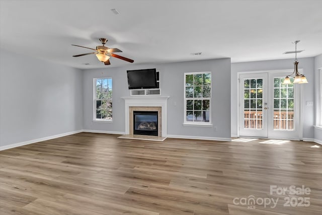 1218 Faversham Ln, Rock Hill, SC 29730 - unfurnished living room featuring french doors, a fireplace, wood finished floors, and ceiling fan