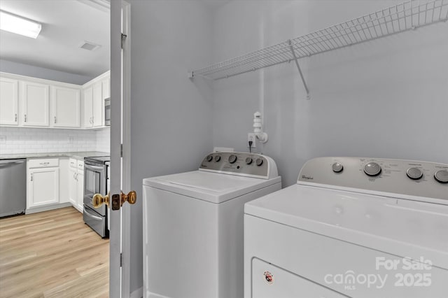 1218 Faversham Ln, Rock Hill, SC 29730 - laundry room with washing machine and dryer and light wood-type flooring