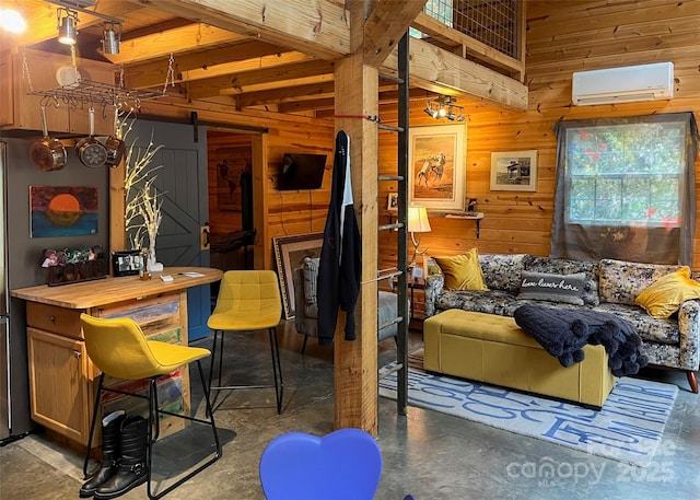 interior space with wood walls, concrete floors, a barn door, and a wall mounted AC