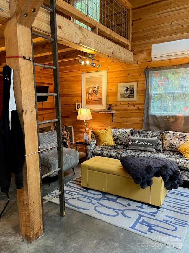 living area featuring a wall mounted air conditioner, wood walls, and unfinished concrete floors