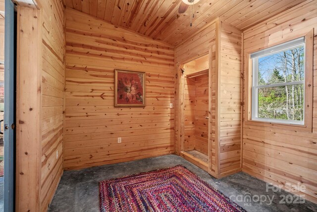 unfurnished room featuring wood walls, carpet, and wood ceiling