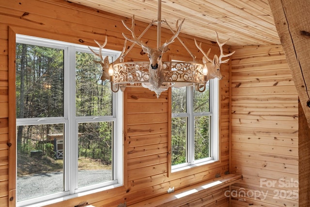 room details with wooden ceiling, a notable chandelier, and wood walls