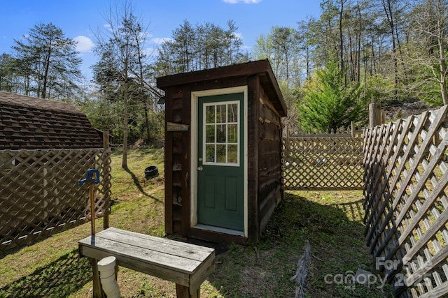 view of shed with fence