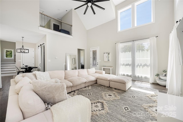 5028 Lewis Rd, Gastonia, NC 28052 - living area featuring high vaulted ceiling, ceiling fan, a barn door, stairway, and wood finished floors