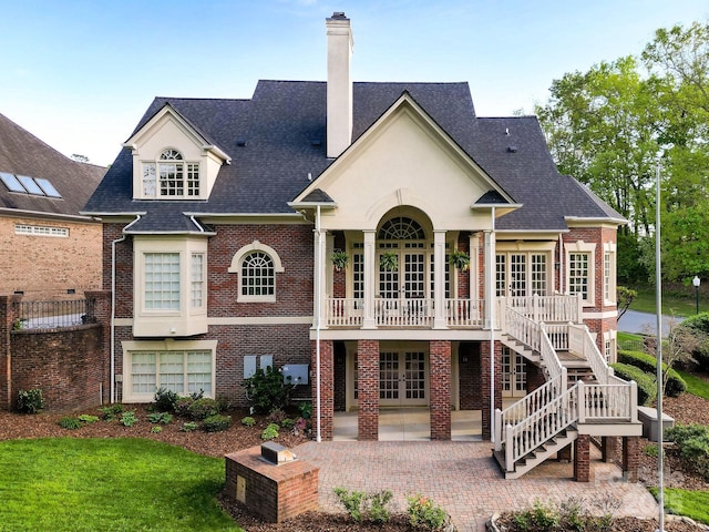 4324 Doverstone Ln, Greensboro, NC 27407 - rear view of house featuring french doors, a chimney, brick siding, a patio area, and a yard