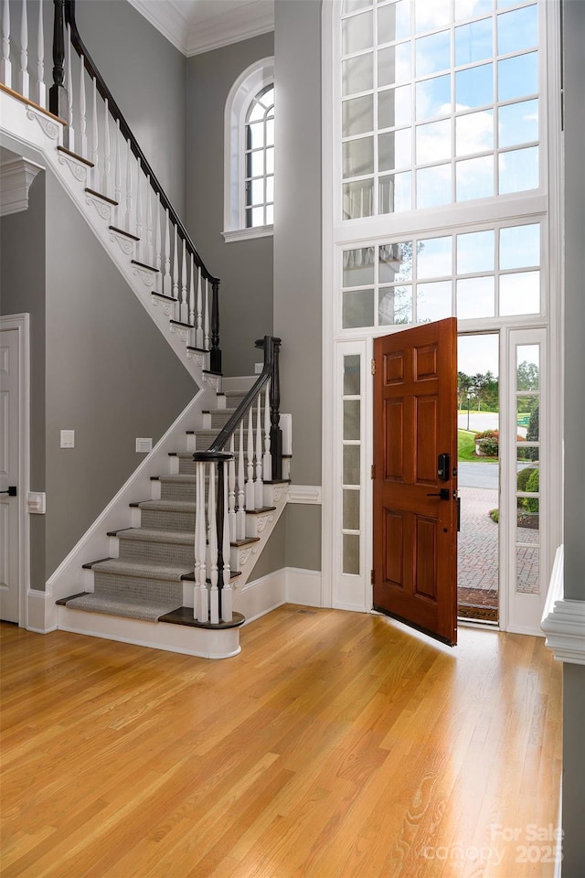 4324 Doverstone Ln, Greensboro, NC 27407 - entryway with ornamental molding, wood finished floors, baseboards, a high ceiling, and stairway