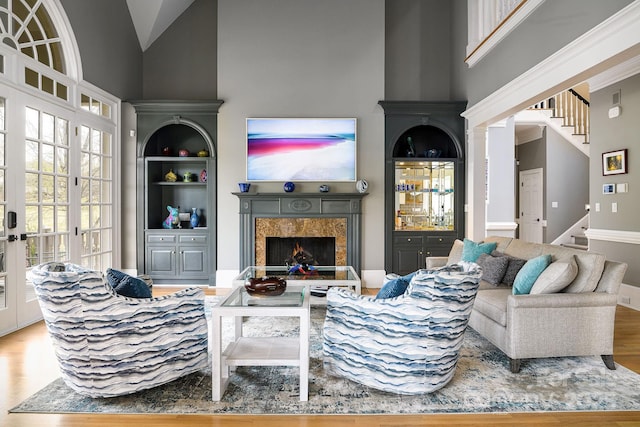 4324 Doverstone Ln, Greensboro, NC 27407 - living area featuring a high end fireplace, wood finished floors, high vaulted ceiling, and stairway