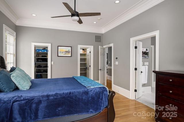 4324 Doverstone Ln, Greensboro, NC 27407 - bedroom with light wood-type flooring, ornamental molding, a walk in closet, and visible vents