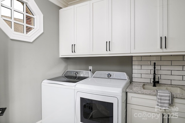 4324 Doverstone Ln, Greensboro, NC 27407 - clothes washing area featuring cabinet space and washing machine and clothes dryer