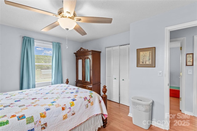 bedroom featuring a closet, light wood finished floors, and ceiling fan