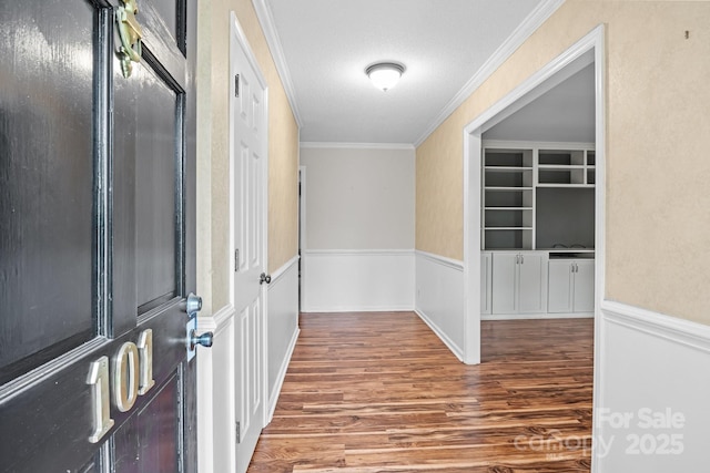 101 Wynnchester Rd, Gastonia, NC 28056 - hall featuring crown molding, a textured ceiling, wainscoting, and wood finished floors