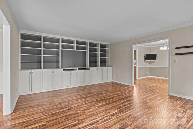 101 Wynnchester Rd, Gastonia, NC 28056 - unfurnished living room with baseboards, ornamental molding, wood finished floors, and a chandelier