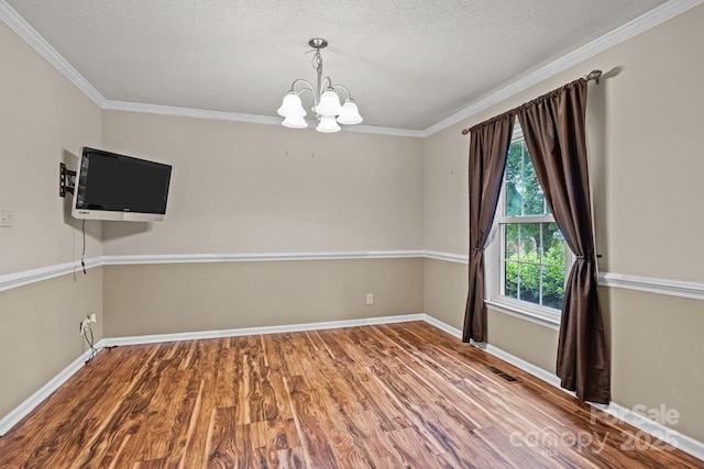 101 Wynnchester Rd, Gastonia, NC 28056 - spare room with crown molding, a textured ceiling, a chandelier, and wood finished floors