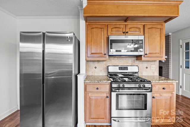 101 Wynnchester Rd, Gastonia, NC 28056 - kitchen with appliances with stainless steel finishes, tasteful backsplash, ornamental molding, and dark wood-style flooring