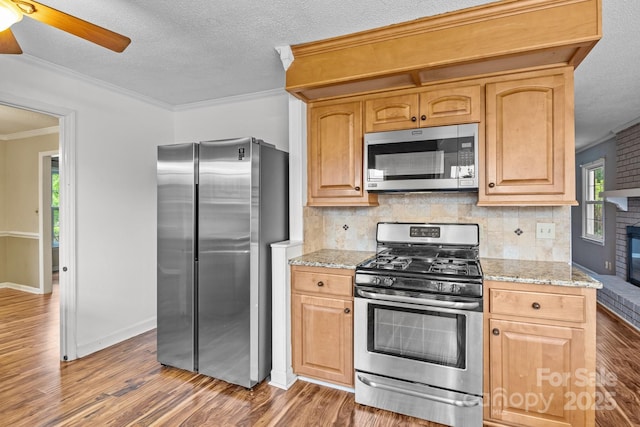 101 Wynnchester Rd, Gastonia, NC 28056 - kitchen with tasteful backsplash, appliances with stainless steel finishes, ornamental molding, and wood finished floors