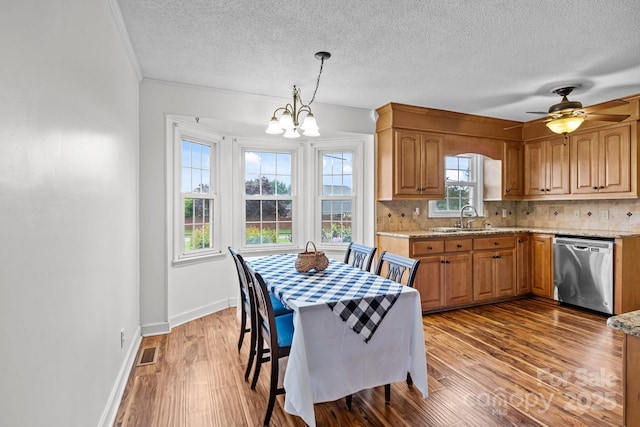 101 Wynnchester Rd, Gastonia, NC 28056 - dining space with a textured ceiling, ceiling fan with notable chandelier, baseboards, wood finished floors, and visible vents