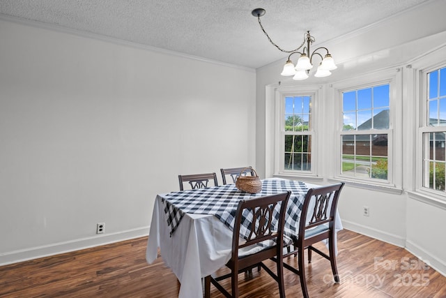 101 Wynnchester Rd, Gastonia, NC 28056 - dining room with a notable chandelier, a textured ceiling, baseboards, wood finished floors, and ornamental molding