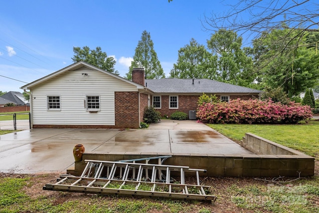 101 Wynnchester Rd, Gastonia, NC 28056 - back of house with fence, a chimney, brick siding, a patio area, and a lawn