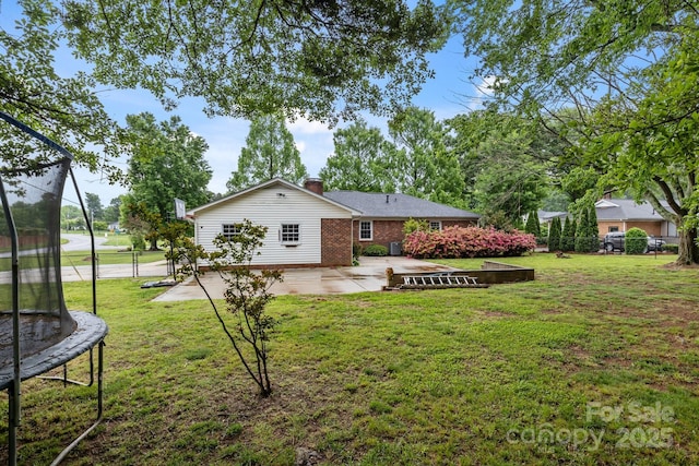 101 Wynnchester Rd, Gastonia, NC 28056 - back of house featuring fence, a patio, a chimney, brick siding, and a trampoline