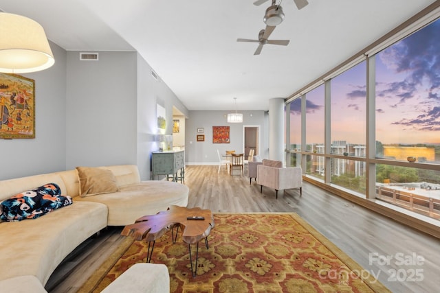 315 Arlington Ave Unit 1104, Charlotte, NC 28203 - living area with baseboards, visible vents, wood finished floors, and ceiling fan