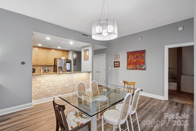 315 Arlington Ave Unit 1104, Charlotte, NC 28203 - dining area with baseboards, visible vents, light wood-type flooring, and recessed lighting