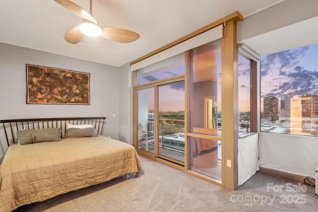 315 Arlington Ave Unit 1104, Charlotte, NC 28203 - bedroom featuring multiple windows, access to outside, and carpet floors