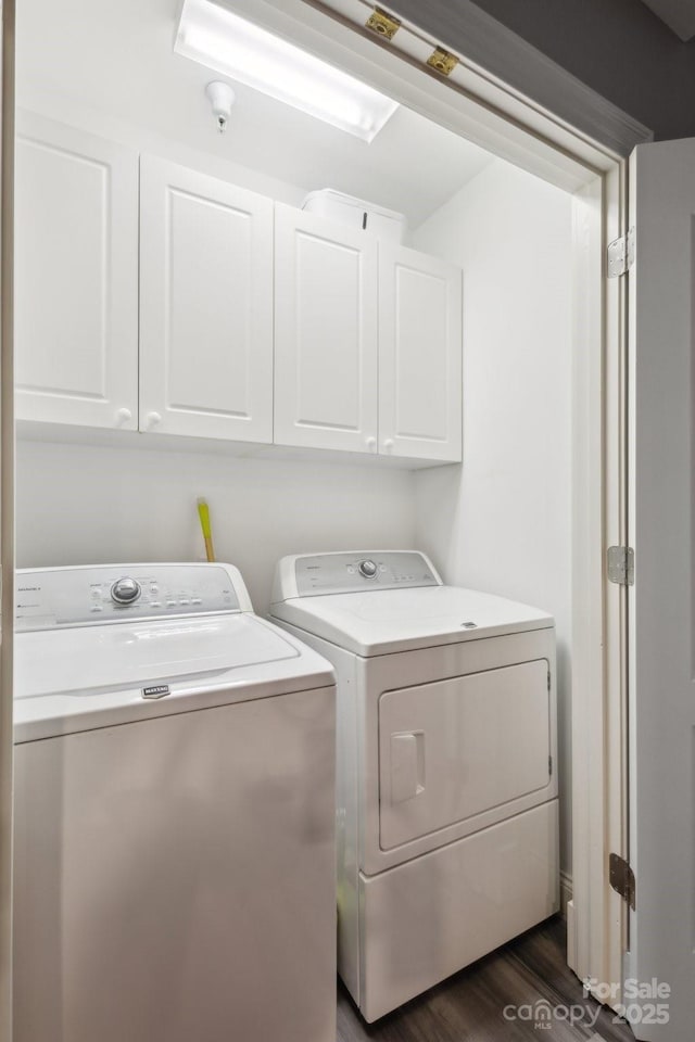 315 Arlington Ave Unit 1104, Charlotte, NC 28203 - clothes washing area with dark wood finished floors, cabinet space, and independent washer and dryer