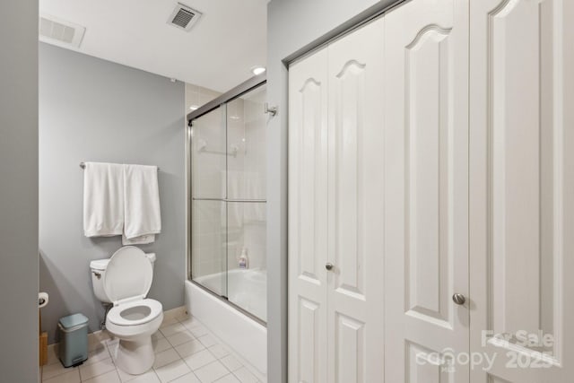 315 Arlington Ave Unit 1104, Charlotte, NC 28203 - full bathroom with bath / shower combo with glass door, visible vents, toilet, and tile patterned flooring