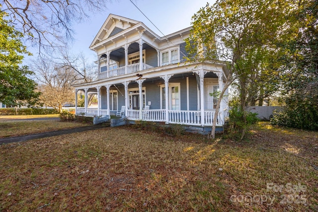 view of front of property with a balcony and covered porch