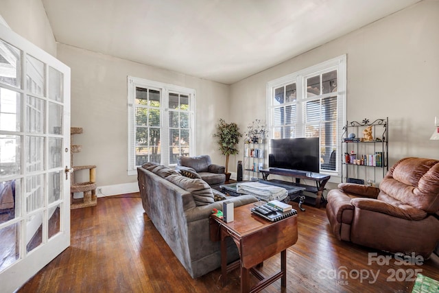 living room with baseboards and dark wood finished floors