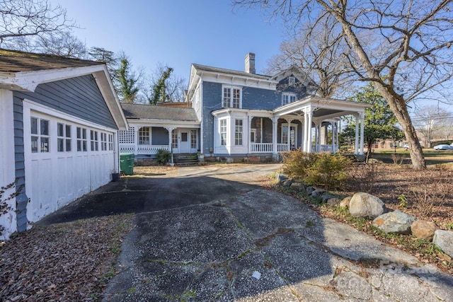 exterior space with covered porch and a chimney