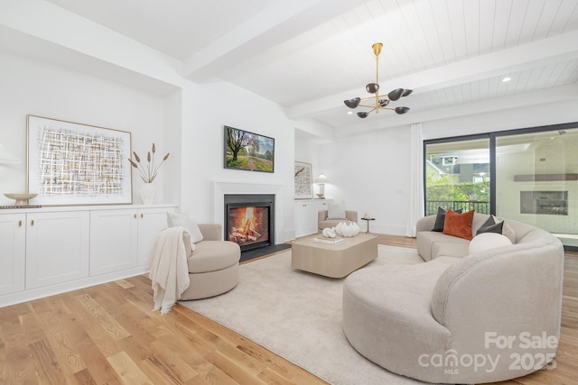 632 Dorothy Dr, Charlotte, NC 28203 - living room with light wood finished floors, a chandelier, a glass covered fireplace, and beamed ceiling