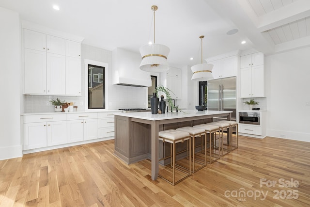 632 Dorothy Dr, Charlotte, NC 28203 - kitchen with stainless steel appliances, tasteful backsplash, recessed lighting, light countertops, and a kitchen bar