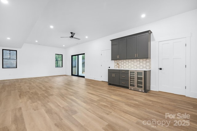 632 Dorothy Dr, Charlotte, NC 28203 - unfurnished living room featuring beverage cooler, light wood-style floors, recessed lighting, ceiling fan, and a dry bar