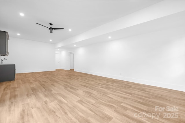 632 Dorothy Dr, Charlotte, NC 28203 - unfurnished living room with a ceiling fan, recessed lighting, light wood-style flooring, and baseboards