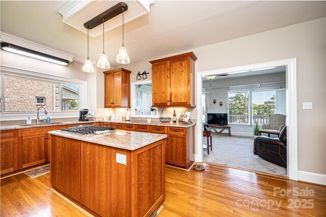 5933 Flintlock Ct, Hickory, NC 28601 - kitchen with a sink, brown cabinetry, stainless steel gas stovetop, and light wood finished floors