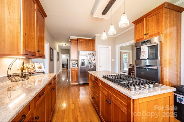 5933 Flintlock Ct, Hickory, NC 28601 - kitchen featuring appliances with stainless steel finishes, light wood finished floors, brown cabinetry, and ornamental molding