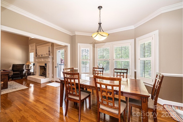 5933 Flintlock Ct, Hickory, NC 28601 - dining space featuring wood finished floors, healthy amount of natural light, ornamental molding, a brick fireplace, and baseboards