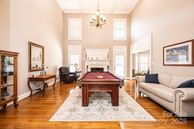 5933 Flintlock Ct, Hickory, NC 28601 - rec room with a towering ceiling, a chandelier, healthy amount of natural light, wood finished floors, and billiards table