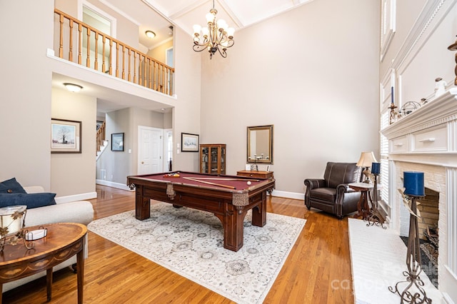 5933 Flintlock Ct, Hickory, NC 28601 - playroom with a fireplace, baseboards, a towering ceiling, light wood-type flooring, and pool table