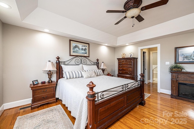5933 Flintlock Ct, Hickory, NC 28601 - bedroom featuring a raised ceiling, baseboards, recessed lighting, light wood-style floors, and ceiling fan