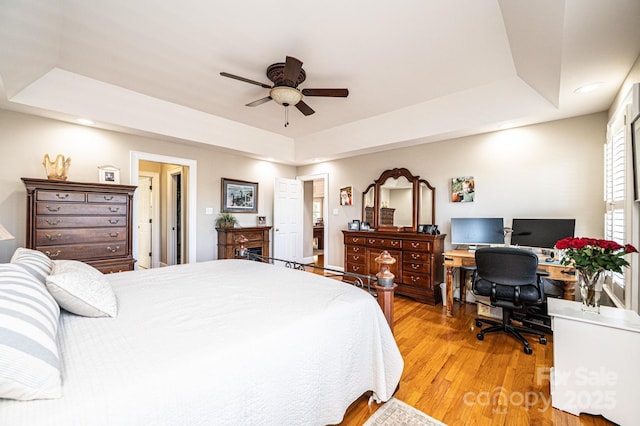 5933 Flintlock Ct, Hickory, NC 28601 - bedroom featuring a raised ceiling, light wood-style flooring, a desk, recessed lighting, and ceiling fan