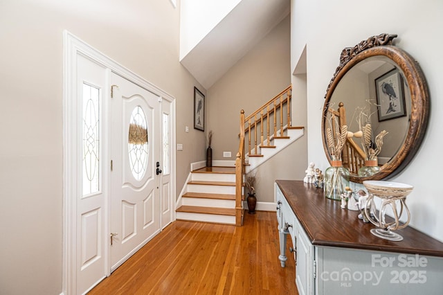 5933 Flintlock Ct, Hickory, NC 28601 - entryway with stairway, light wood finished floors, baseboards, and high vaulted ceiling