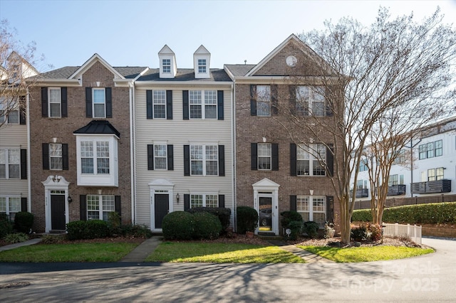 view of property featuring brick siding