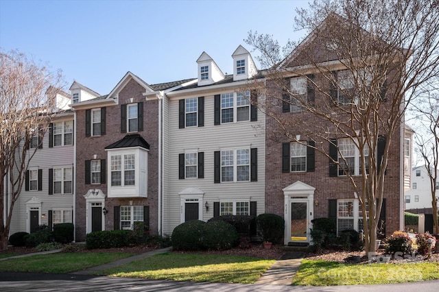 townhome / multi-family property featuring brick siding