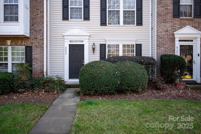 property entrance featuring brick siding